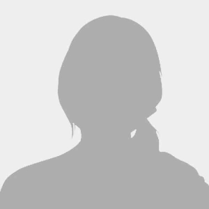Placeholder image representing a team member with a silhouette of a woman against a gray background.